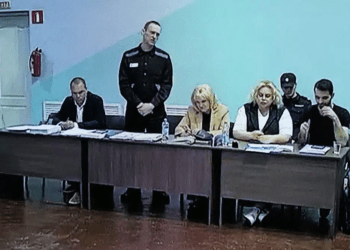 A view of a TV Screen showing Russian opposition leader, Alexei Navalny, 2nd left, between his lawyers in a courtroom, during a preliminary hearing, in Melekhovo on Monday, June 19, 2023.