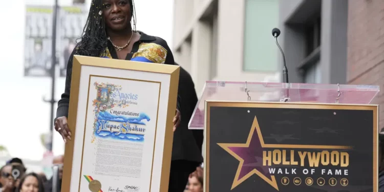 Sekyiwa "Set" Shakur holds a plaque at a ceremony honoring her brother, the late rapper and actor Tupac Shakur
