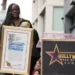 Sekyiwa "Set" Shakur holds a plaque at a ceremony honoring her brother, the late rapper and actor Tupac Shakur