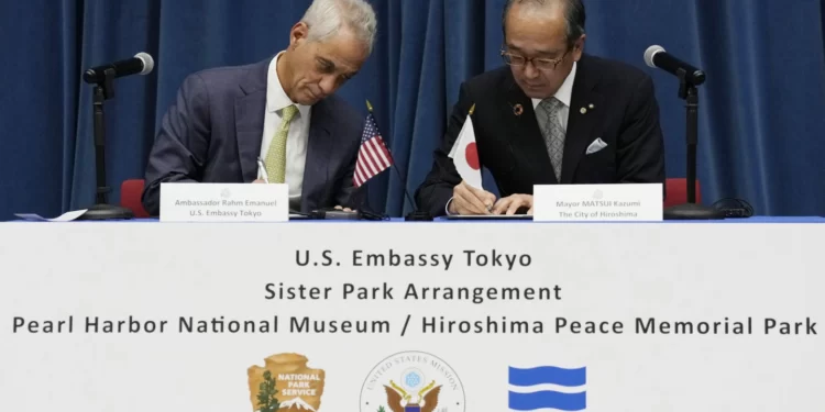 U.S Ambassador to Japan, Rahm Emanuel, left, and Hiroshima Mayor, Kazumi Matsui sign a sister park agreement between the Pearl Habor National Memorial and the Hiroshima Peace Memorial Park , June 29, 2023, in Tokyo.
