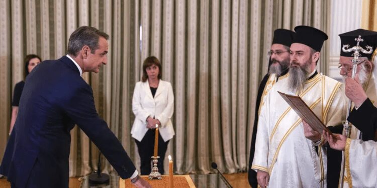 Mitsotakis Sworn In As Prime Minister After Landslide Election Victory 1 Greece's Prime Minister Kyriakos Mitsotakis, left, takes the oath during a swearing in ceremony at the Presidential palace, in Athens, Greece, Monday, June 26, 2023.