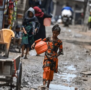 A Rohingya girl walks through a refugee camp in Delhi.