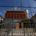The city hall in L'Hay-les-Roses, where the mayor's home was ram-raided and set alight, is protected by a security fence.