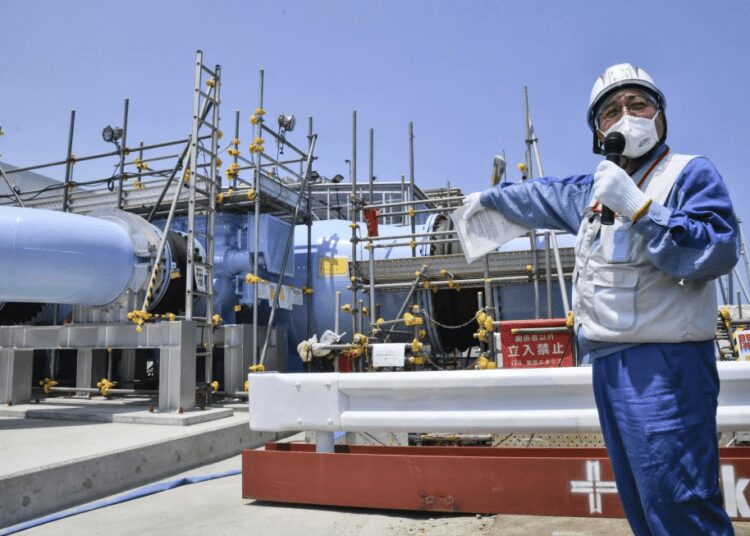 An employee of Tokyo Electric Power Company explains to the media about the facility to be used to release treated radioactive water at Fukushima Daiichi nuclear power plant in Fukushima, northern Japan, on June 26, 2023.