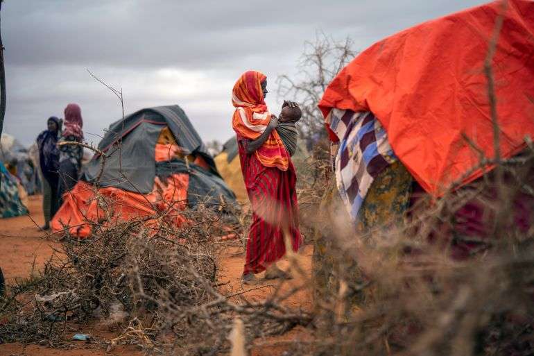 A Somali woman cares for her child at a camp for displaced people on the outskirts of Dolow Somalia