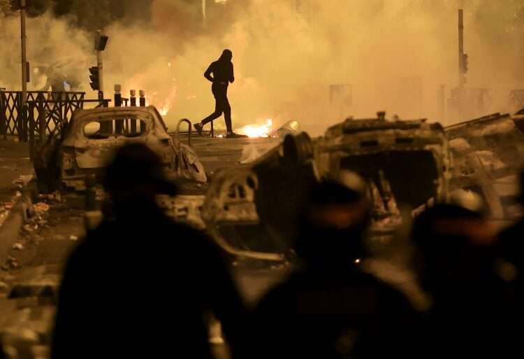 The Ambiguous Law That Cost Nahel His Life 1 A demonstrator runs on the third night of protests sparked by the fatal police shooting of a 17-year-old driver in the Paris suburb of Nanterre, France.