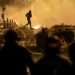 A demonstrator runs on the third night of protests sparked by the fatal police shooting of a 17-year-old driver in the Paris suburb of Nanterre, France.