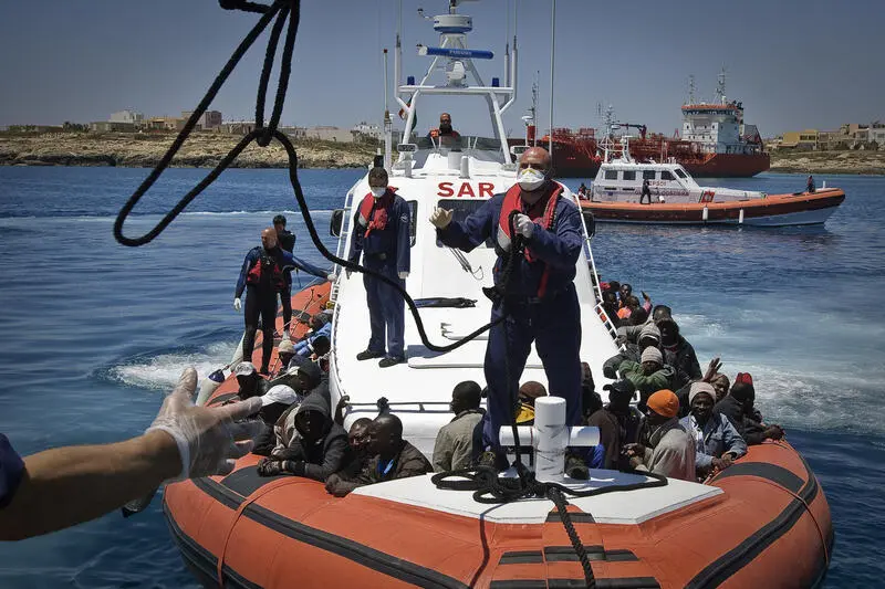 An Italian coastguard vessel prepares to dock in Lampedusa port