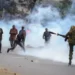 Kenyans To Stage Another Protest Against Government's Introduction Of New Taxes 11 Kenyan demonstrators throwing stones at a security Personnel.