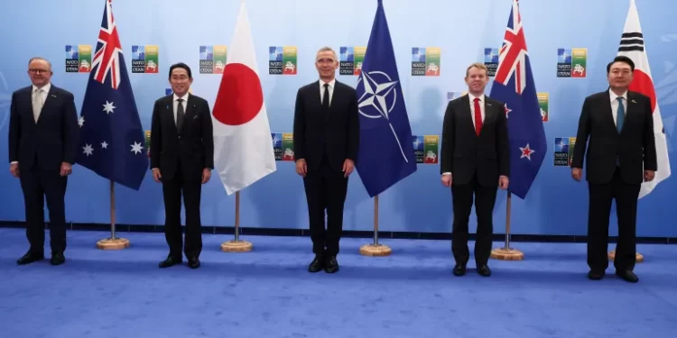 Leaders from Asia pose for a group photo with NATO Secretary General Jens Stoltenberg in Vilnius.