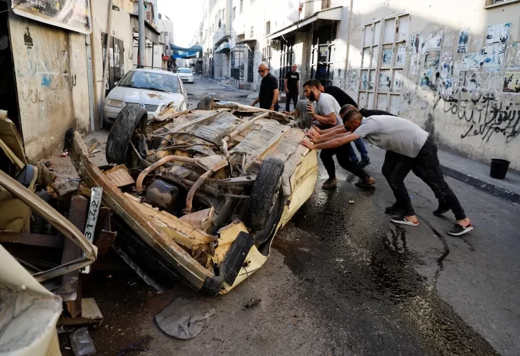 Israeli Troops Withdraw From Jenin Camp After 2-Day Raid 1 Palestinians try to move a damaged car after the Israeli forces’ withdrawal from the Jenin camp.