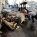 Palestinians try to move a damaged car after the Israeli forces’ withdrawal from the Jenin camp.