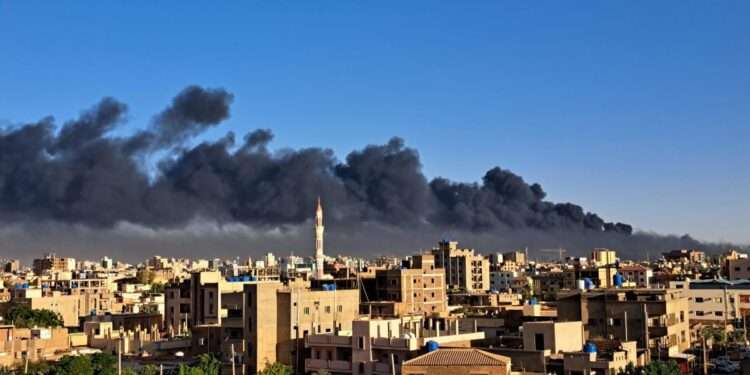 Smoke billows behind buildings in the Sudanese capital, Khartoum.