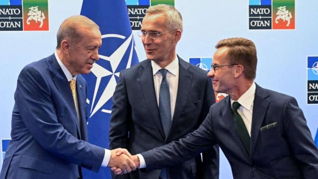 Turkish President Tayyip Erdogan and Swedish Prime Minister Ulf Kristersson shake hands next to Nato secretary general Jens Stoltenberg on eve of Nato summit in Vilnius Lithuania