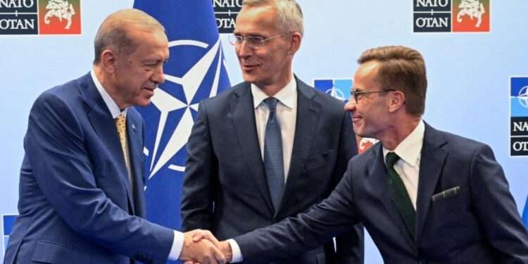 Turkish-President-Tayyip-Erdogan-and-Swedish-Prime-Minister-Ulf-Kristersson-shake-hands-next-to-Nato-secretary-general-Jens-Stoltenberg on eve of NATO summit in Vilnius, Lithuania