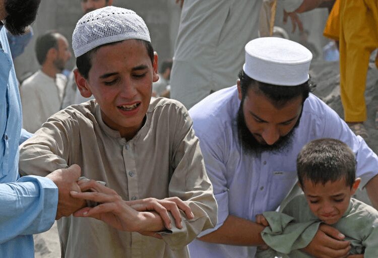 Pakistan Carries Out Burials As Death Toll From Rally Bomb Explosion Rises To 54 1 Boys weep over the death of a family member at a funeral a day after bomb blast in the Bajaur district of Pakistan's Khyber-Pakhtunkhwa province targeted a political rally, July 31, 2023.