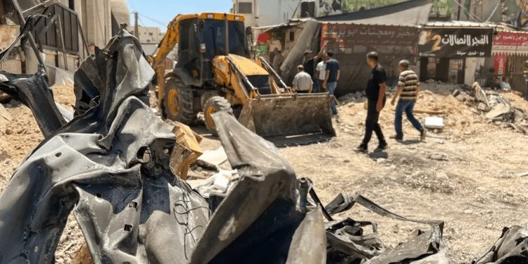 UAE Pledges $15 Million Towards Rebuilding The Raided Jenin Refugee Camp 1 Palestinians walk on a damaged road in the Jenin Refugee Camp in the West Bank.