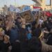 Iraqis raise copies of the Quran, Muslims’ holy book, during a protest in Tahrir Square in Baghdad, Iraq.