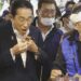 Japan's Prime Minister, Fumio Kishida tries seafood at the Toyosu fish market.