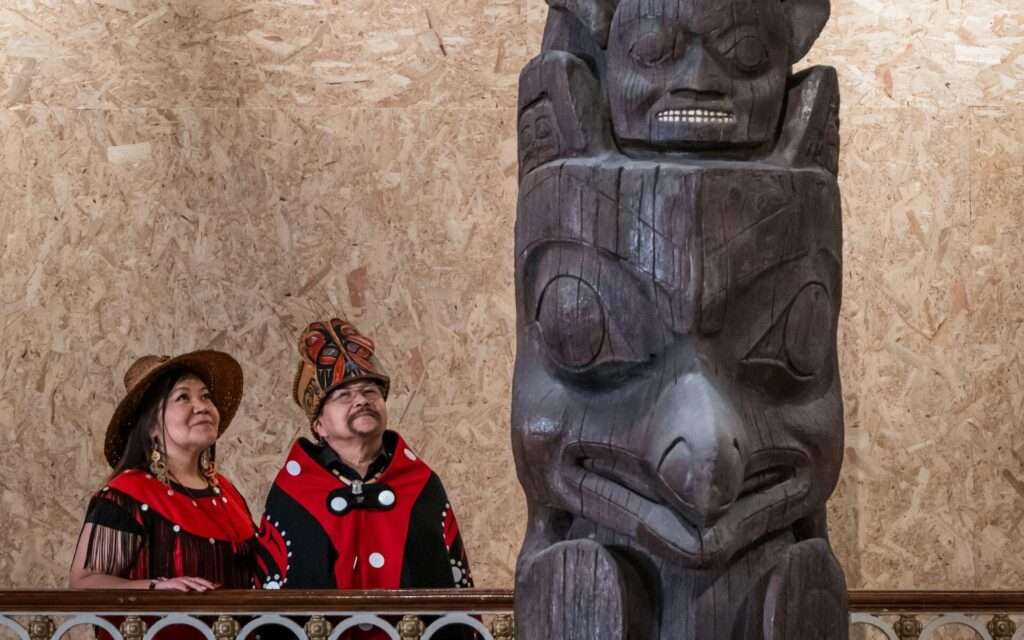 A delegation from the Nisgaa nation admire their pole at the National Museum of Scotland