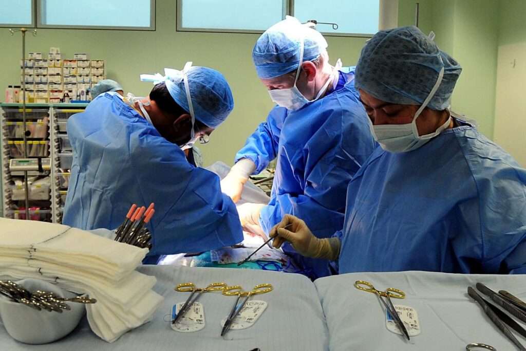 Doctors performing surgery on a patient. 2.0