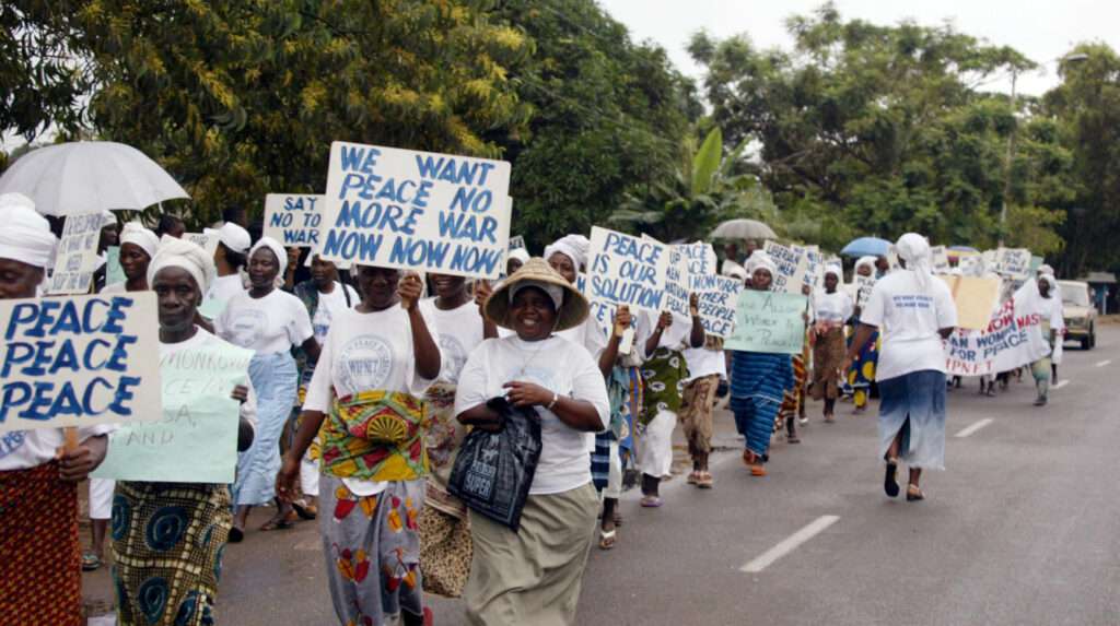 Liberian women marching through the streets of Monrovia agitating for peace