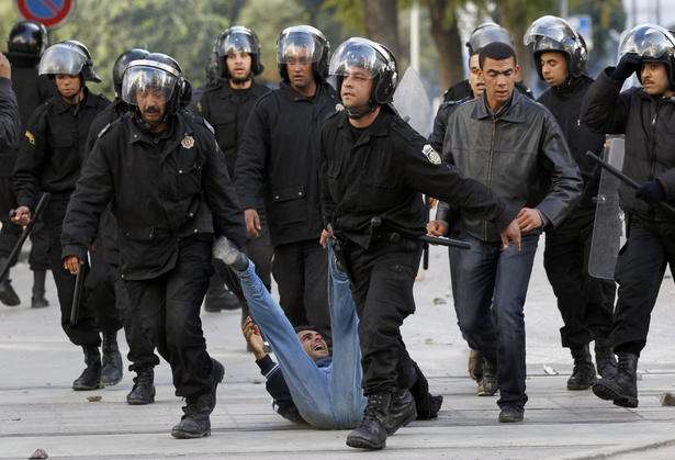 Police drags a protester on the ground