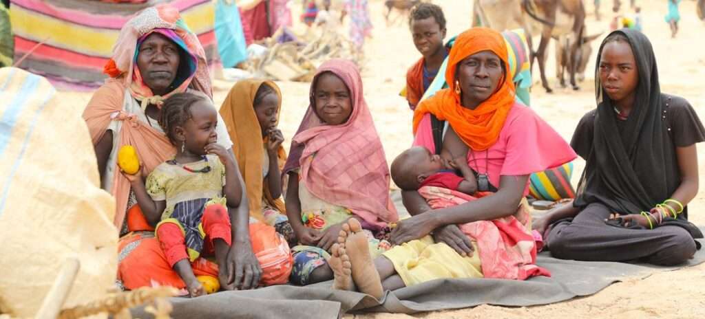 Sudanese family take shelter at a refugee entry point close to the Chadian border with Sudan