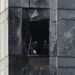 People inspect the damage sustained to a building of the Moscow International Business Centre (Moskva City) following a drone attack in Moscow on August 23, 2023.