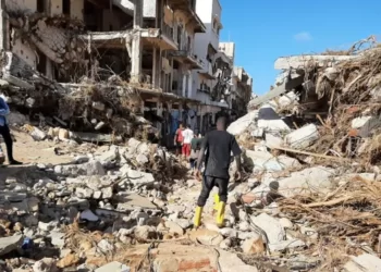 Members of Libyan Red Crescent work in an area affected by flooding in Derna.