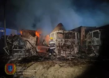 Rescuers working to put out a fire after an overnight attack on seaport infrastructure in the Odesa region.