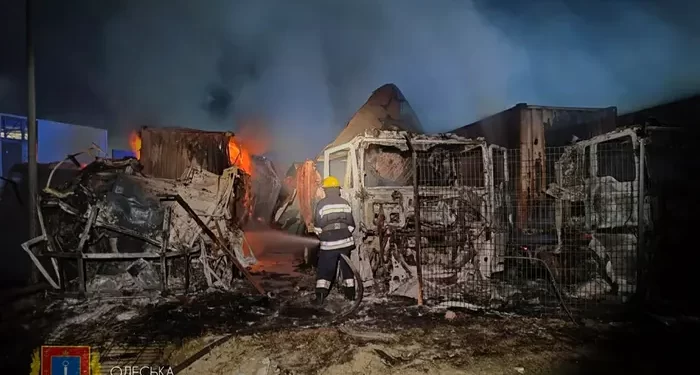 Rescuers working to put out a fire after an overnight attack on seaport infrastructure in the Odesa region.