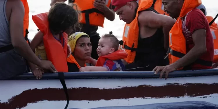 Eighteen people on a small wooden boat near the Italian island of Lampedusa, in the Mediterranean Sea, in 2021.