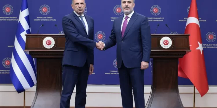 Turkish Foreign Minister, Hakan Fidan shakes hands with his Greek counterpart, George Gerapetritis during a news conference in Ankara, Turkey.