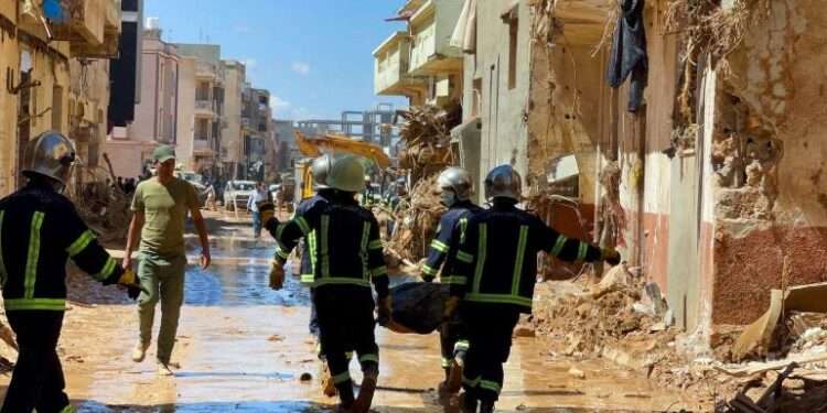 Rescue workers carry a body bag.