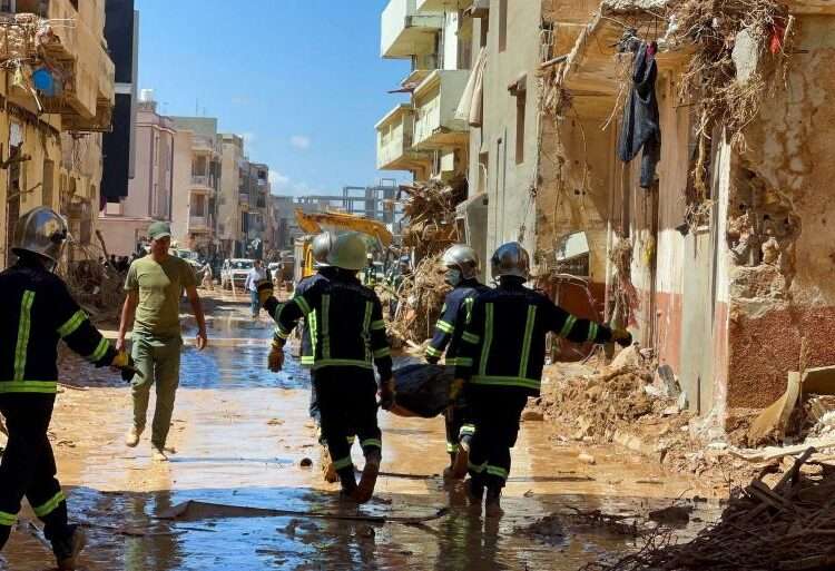 Rescue workers carry a body bag.