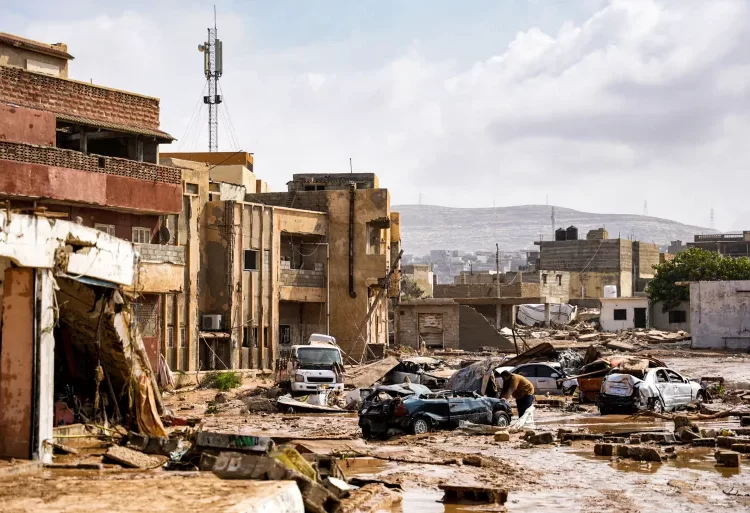 Destroyed vehicles and damaged buildings in the eastern city of Derna, about 290 kilometres (180 miles) east of Benghazi.