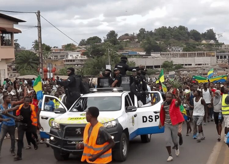 African Democracy Under Siege 1 This video grab shows coup supporters cheering police officers in Libreville, Gabon, on Aug. 30, 2023.