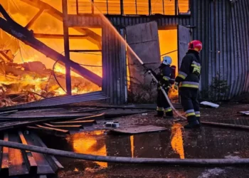 Firefighters work at the site of an industrial warehouse after a Russian drone strike on Lviv.