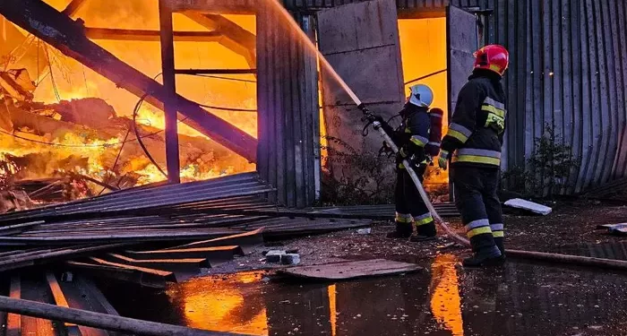 Firefighters work at the site of an industrial warehouse after a Russian drone strike on Lviv.