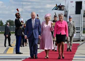 French Prime Minister Elisabeth Borne (R) greets Britain's King Charles III and Britain's Queen Camilla (C) upon their arrival at the Orly Airport on September 20, 2023, on the first day of a state visit to France.
