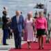 French Prime Minister Elisabeth Borne (R) greets Britain's King Charles III and Britain's Queen Camilla (C) upon their arrival at the Orly Airport on September 20, 2023, on the first day of a state visit to France.