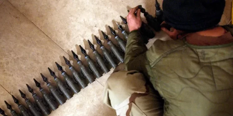 A US soldier with 25mm rounds of depleted uranium ammunition at his base in Tikrit, Iraq, in 2004.