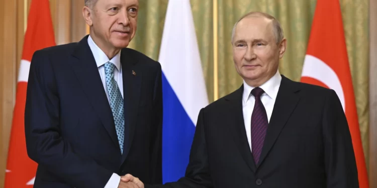 Turkish President, Recep Tayyip Erdogan, left, shakes hands with Russia's President, Vladimir Putin.