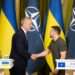 NATO Secretary General, Jens Stoltenberg, left, shakes hands with President Volodymyr Zelenskyy.