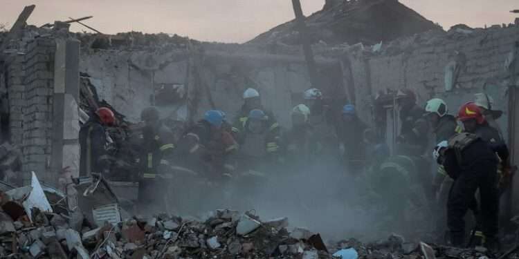 Rescuers work at a site of a Russian military strike in the village of Hroza, in Kharkiv region, Ukraine.