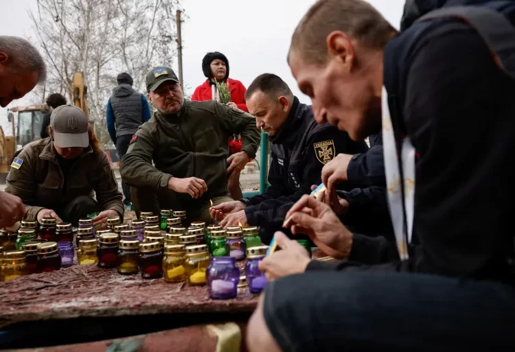 UN To Investigate Missile Attack in Kharkiv 1 People light candles and lay flowers, paying tribute on October 6, 2023, to the victims of a Russian military strike on a village in the Kharkiv region.