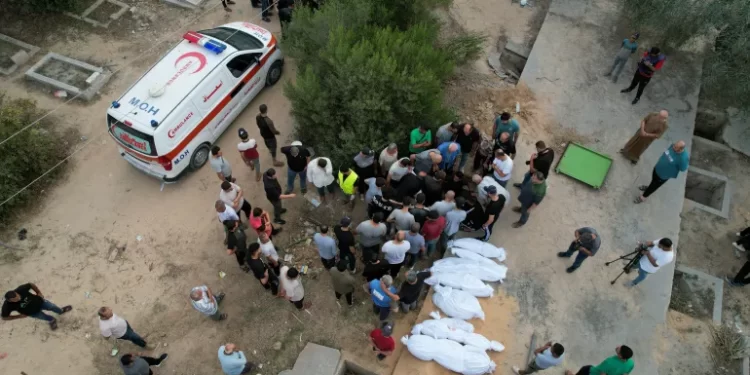 International Community Urged To Put People Before Politics 1 People bury the bodies of Palestinians killed in Israeli strikes at a cemetery, in the central Gaza Strip.