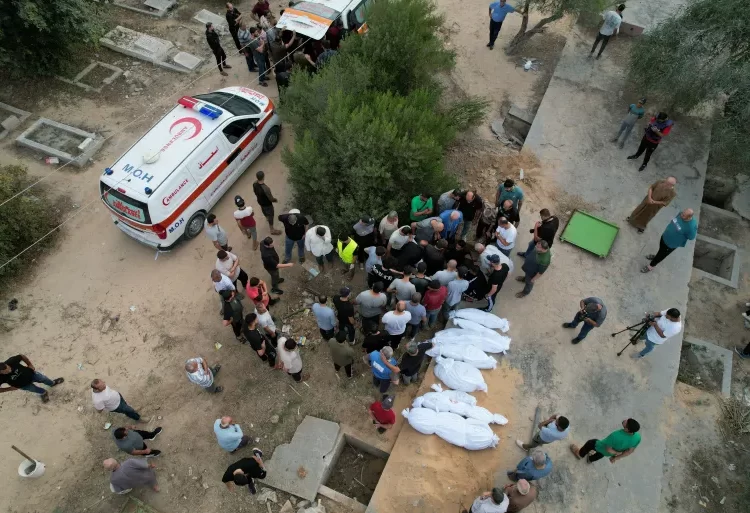 International Community Urged To Put People Before Politics 1 People bury the bodies of Palestinians killed in Israeli strikes at a cemetery, in the central Gaza Strip.