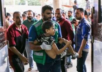 A medic carries a Palestinian child injured in Khan Younis in the southern Gaza Strip.